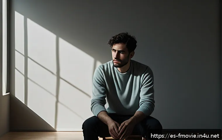 호아킨 피닉스 출연작 - A deeply introspective and tormented male character sitting alone in a dimly lit room, wearing simpl...